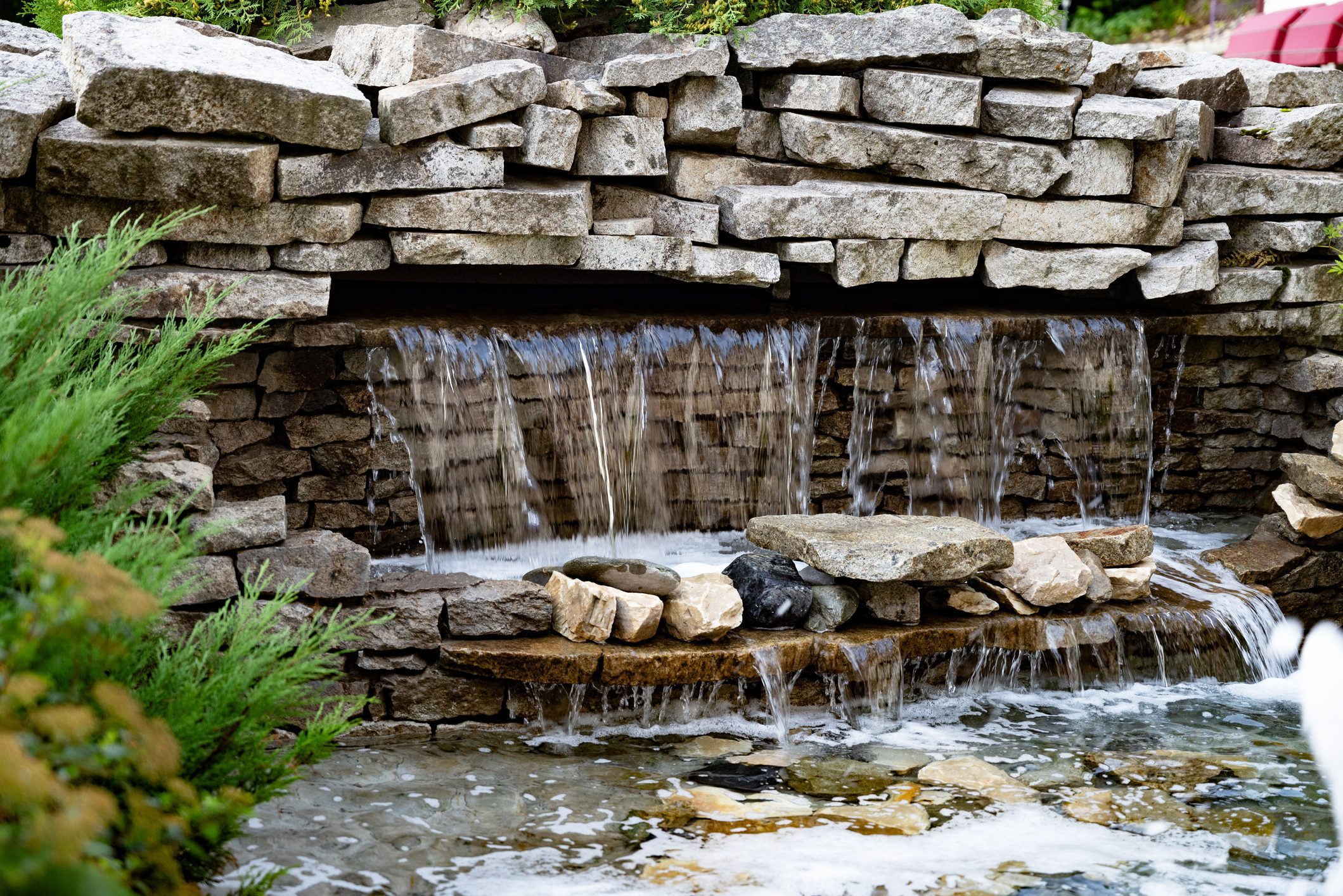 Stone waterfall feature in garden