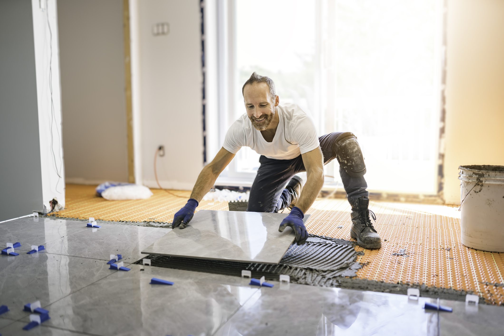 Worker laying ceramic tiles