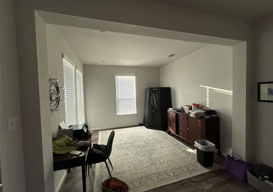 Home office with rug, desk, and storage